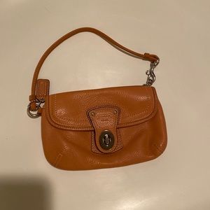 Coach orange wristlet with twist lock fastener